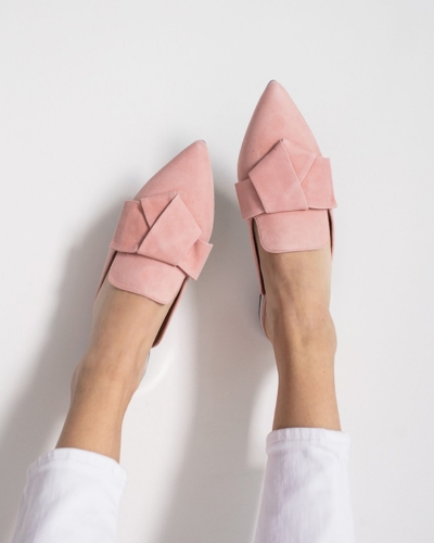 Lady's feet wearing pink shoes up in the air
